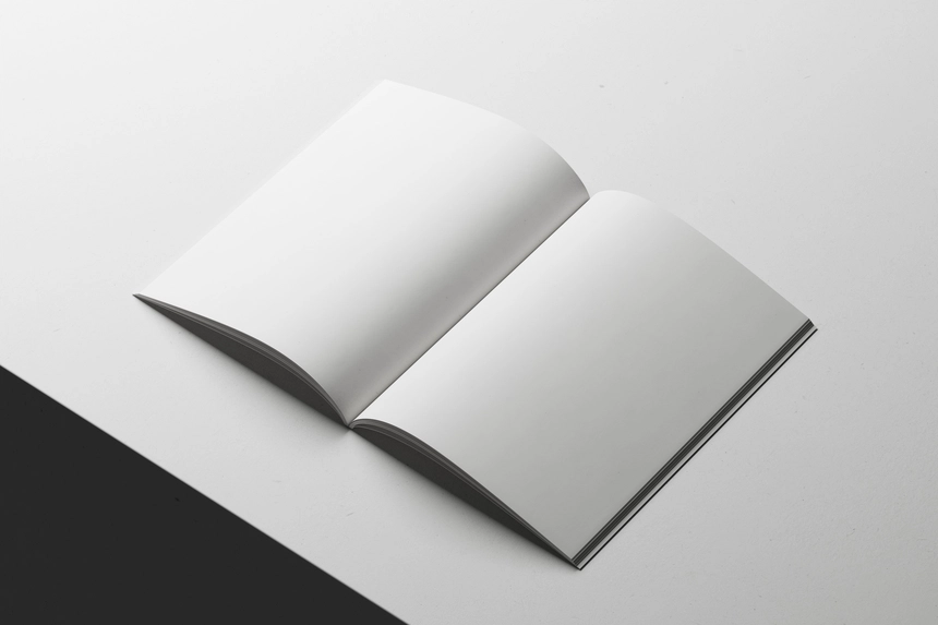 Free-A4-Magazine-Mockup-Open-on-White-Surface-PSD.webp