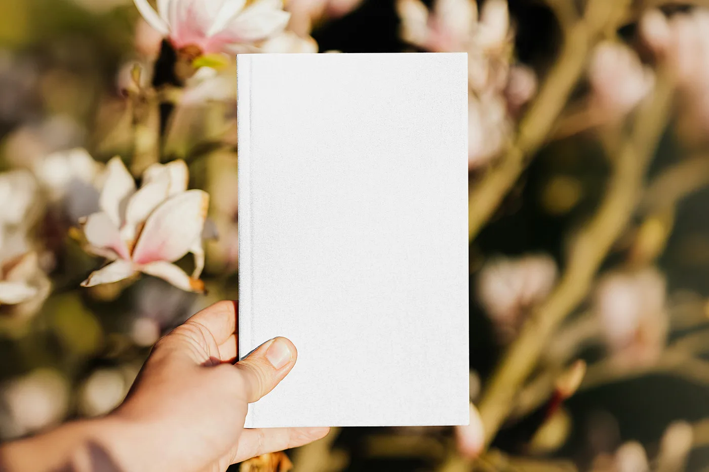 Free-Hardcover-Book-in-Hand-Mockup.webp