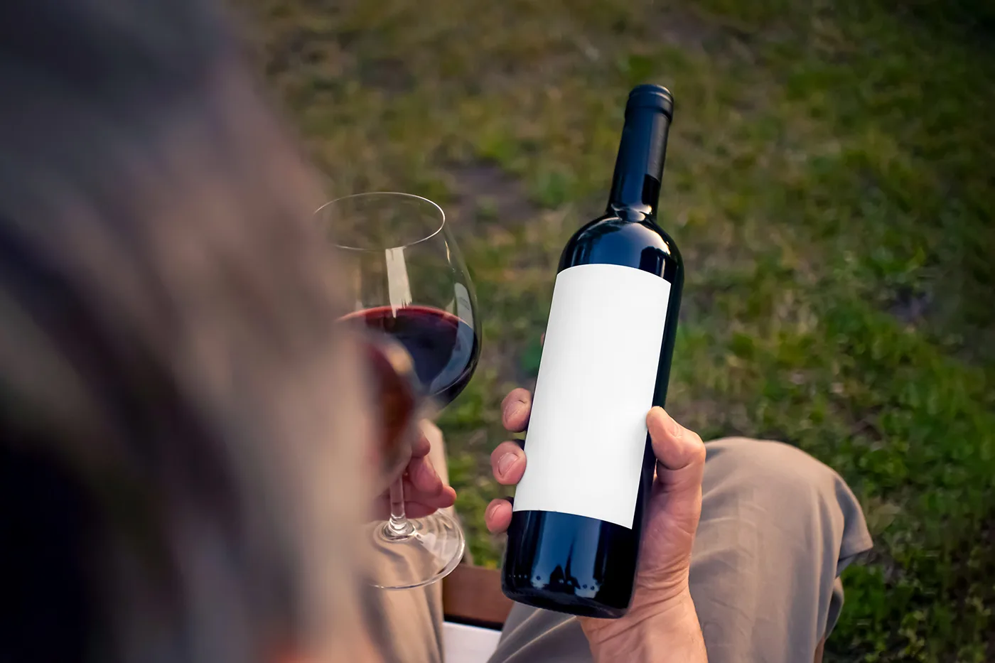 Free-Wine-Bottle-in-Hand-Mockup-PSD.webp