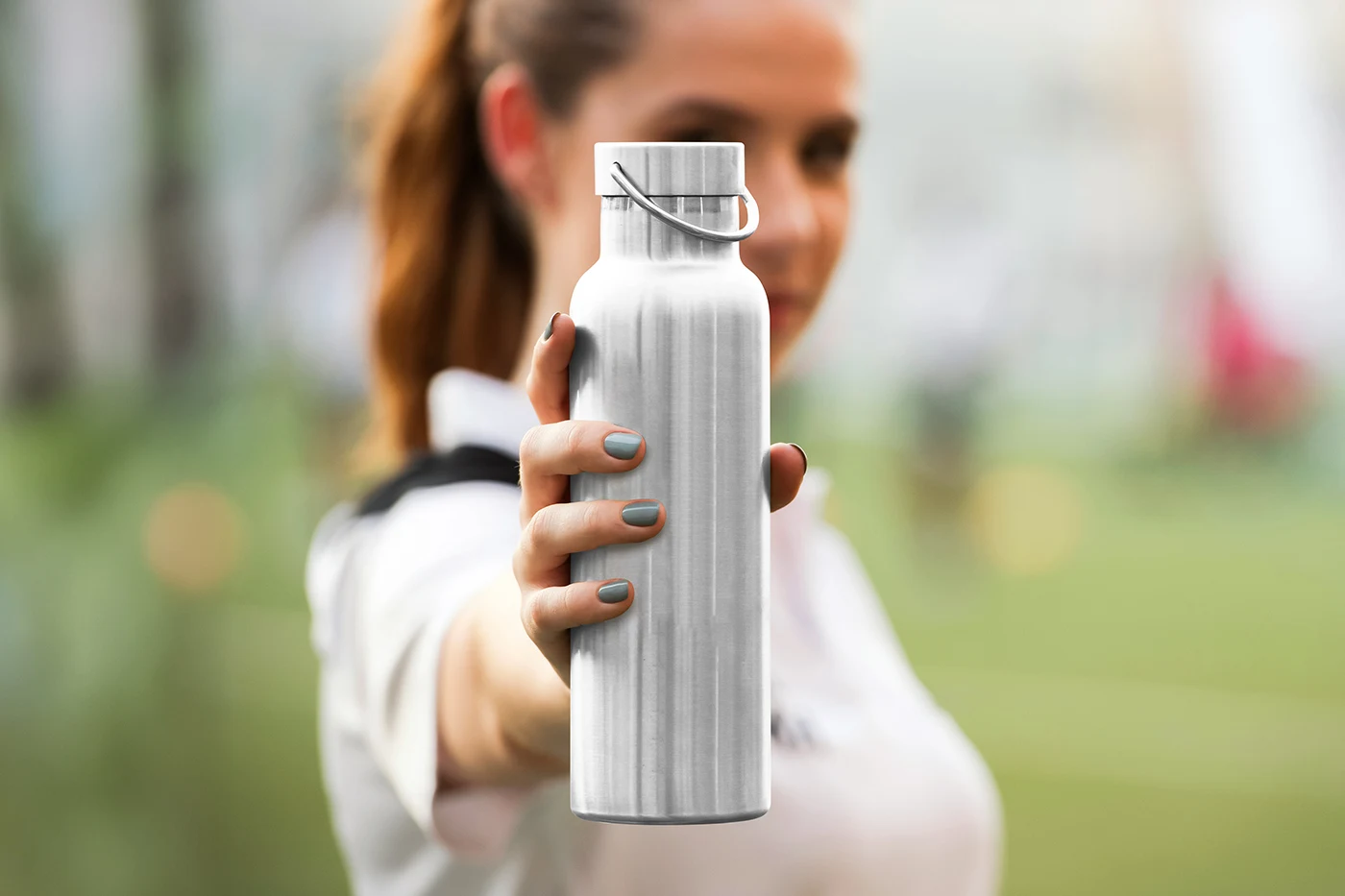 Metal-Water-Bottle-in-Hand-Mockup.webp
